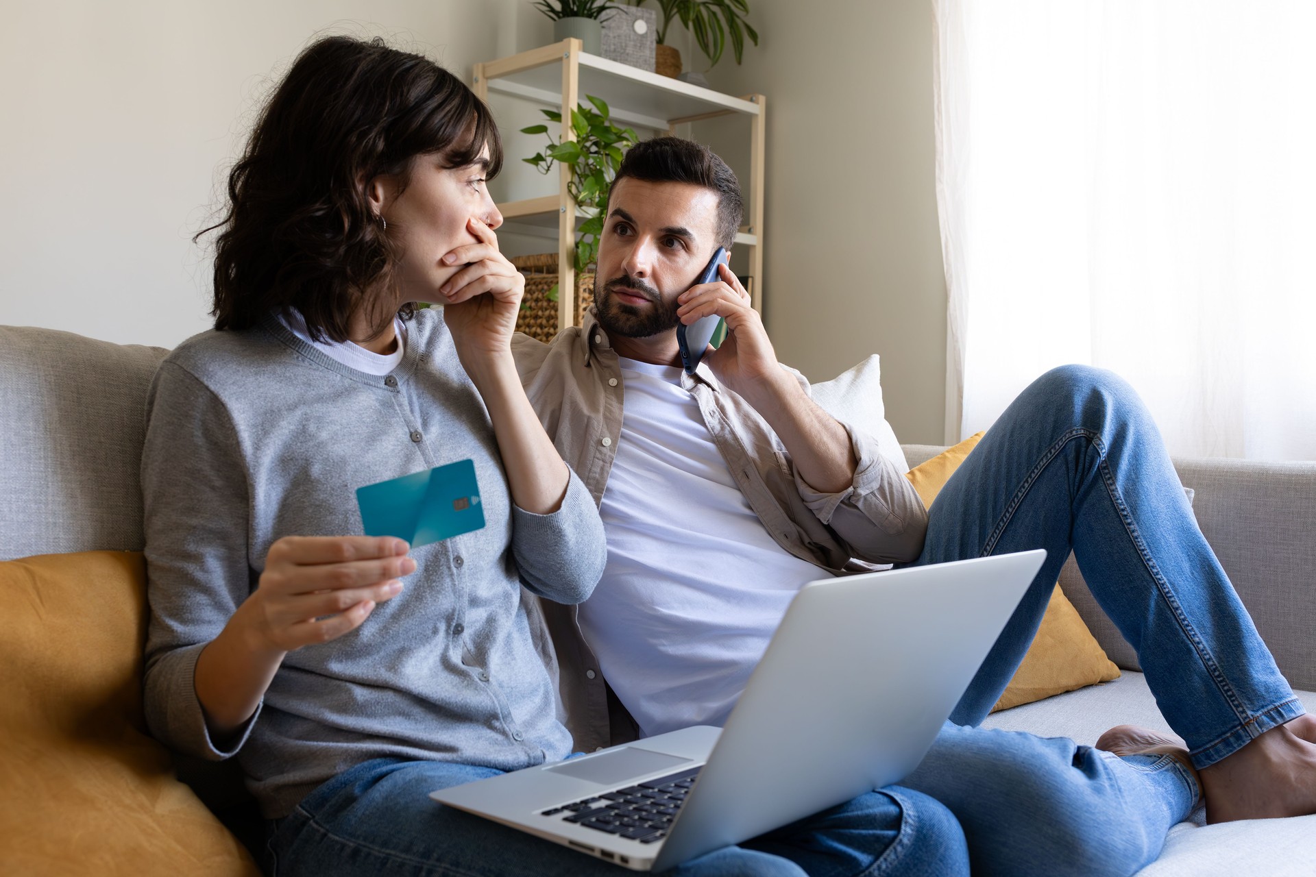 Worried couple facing online payment problems on laptop